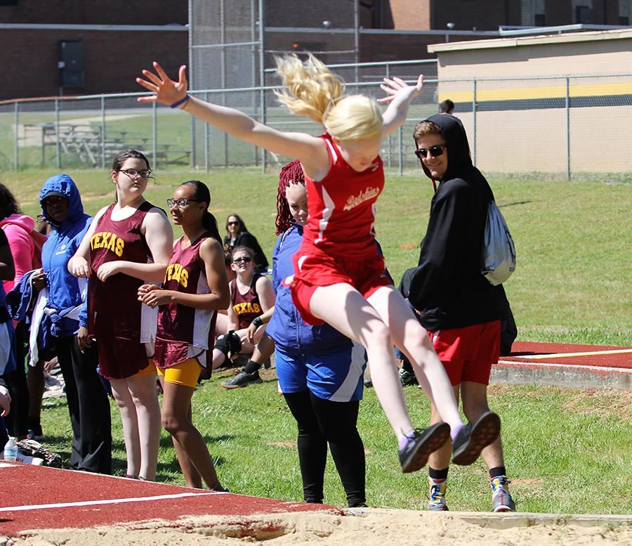 A member of the ASB girls' track team competes in the long jump event A member of the ASB girls' track team competes in the long jump event