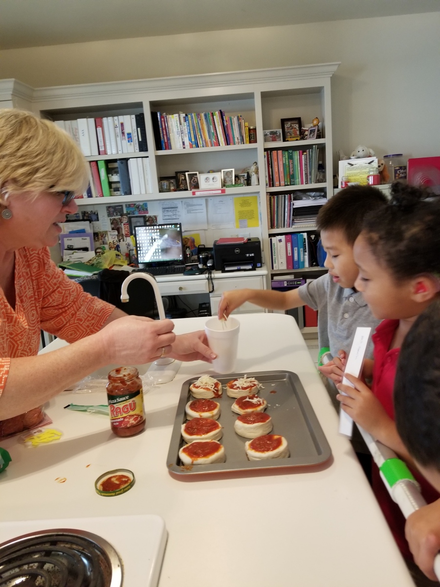 Speech Therapist works with two students on a cooking activity. 