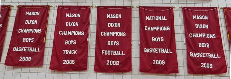 Photo of many ASD athletic championship banners on display in the gym Photo of many ASD athletic championship banners on display in the gym
