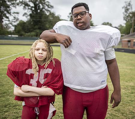 Two ASD football players pose for a photo during practice 