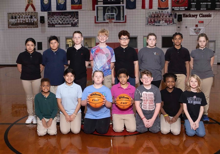 Boys and girls basketball players side by side and look to camera.