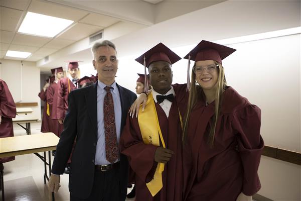 John Mascia, Au.D., President of AIDB, smiles with two graduates from Alabama School for the Deaf.