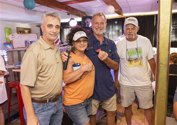 Jada, Dr. Mascia, Johnny Vetra and Tim smile to camera. 