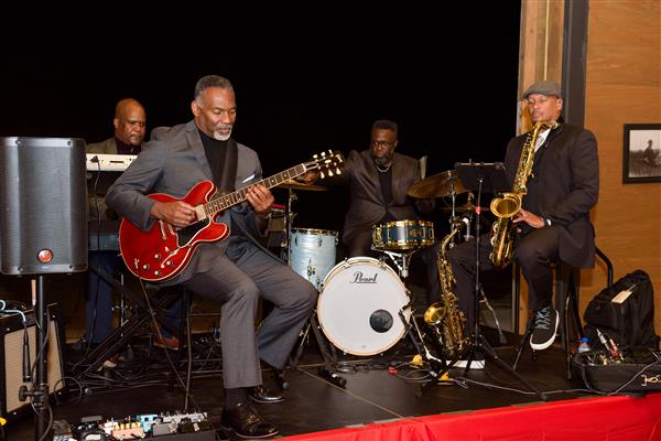 Eric Essix and his quartet band perform on a stage. 